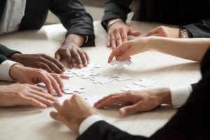 close-up-multiethnic-team-solving-blank-puzzle-game close-up-multiethnic-team-solving-blank-puzzle-game